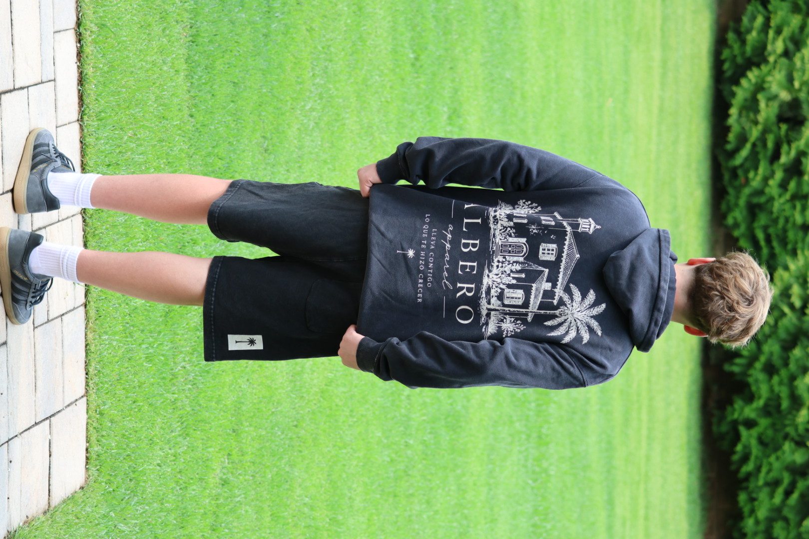 Model wearing the Albero Signature Hoodie from behind — Lleva contigo lo que te hizo crecer